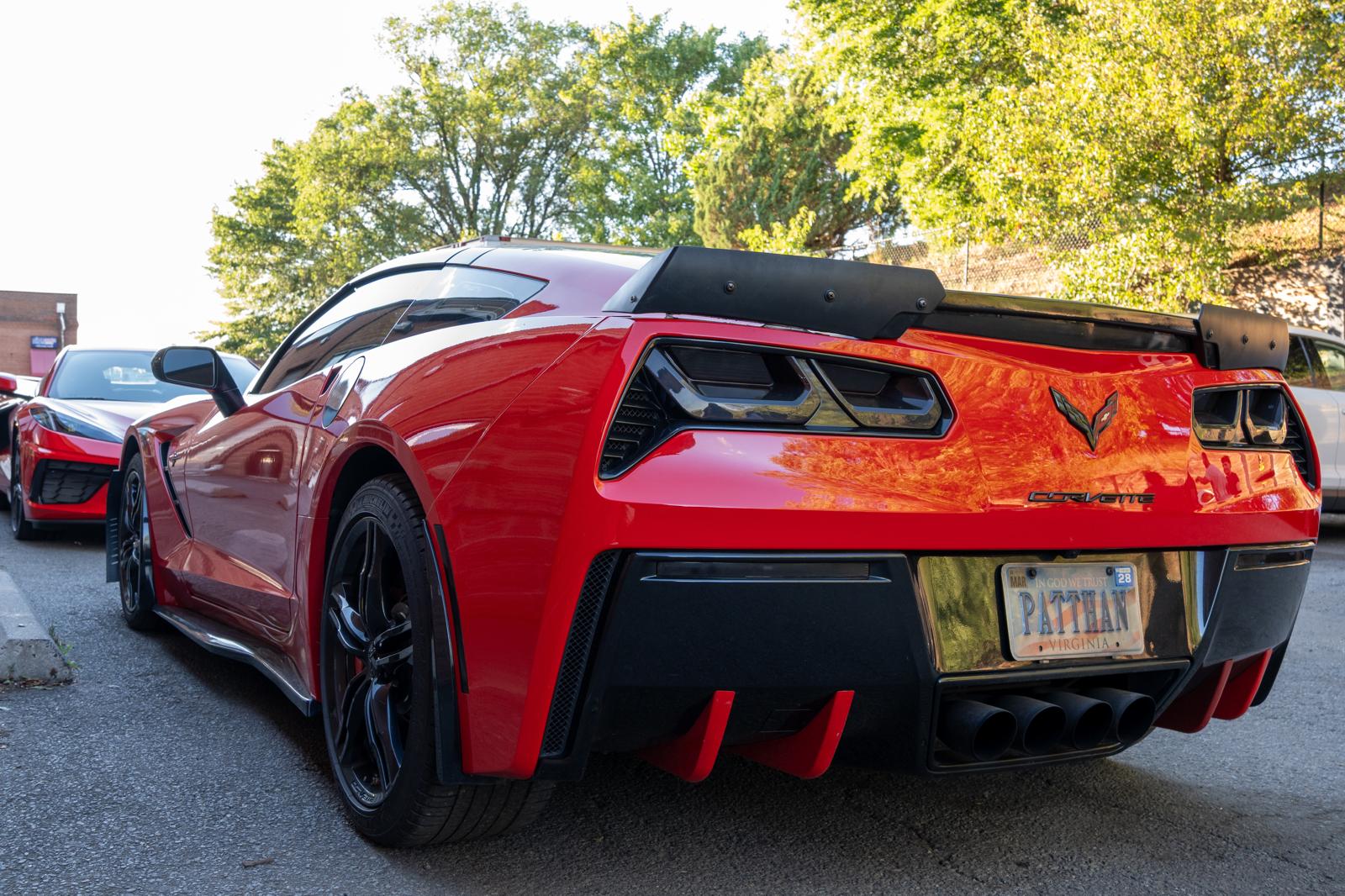 Red Corvette Stingray parked outside the Unique Auto Mobile Care shop