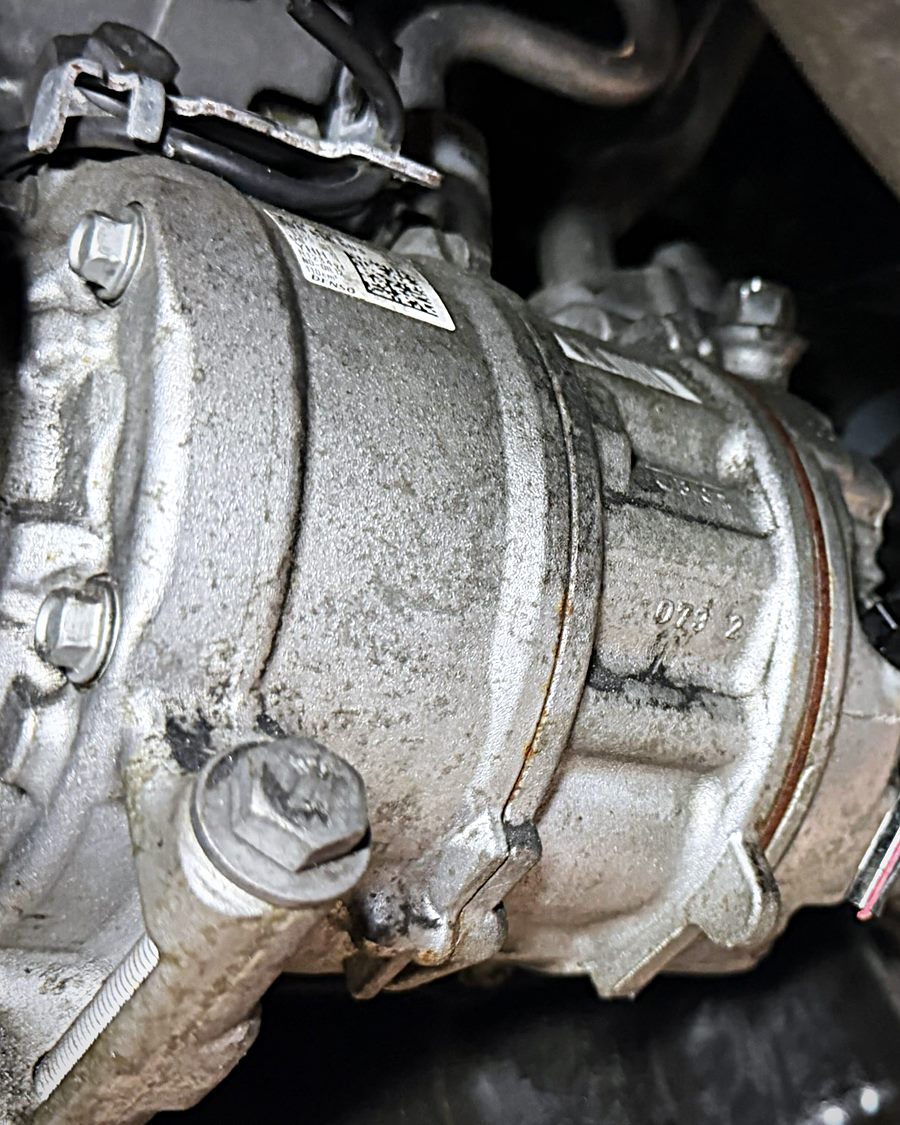 A/C compressor mounted on an engine