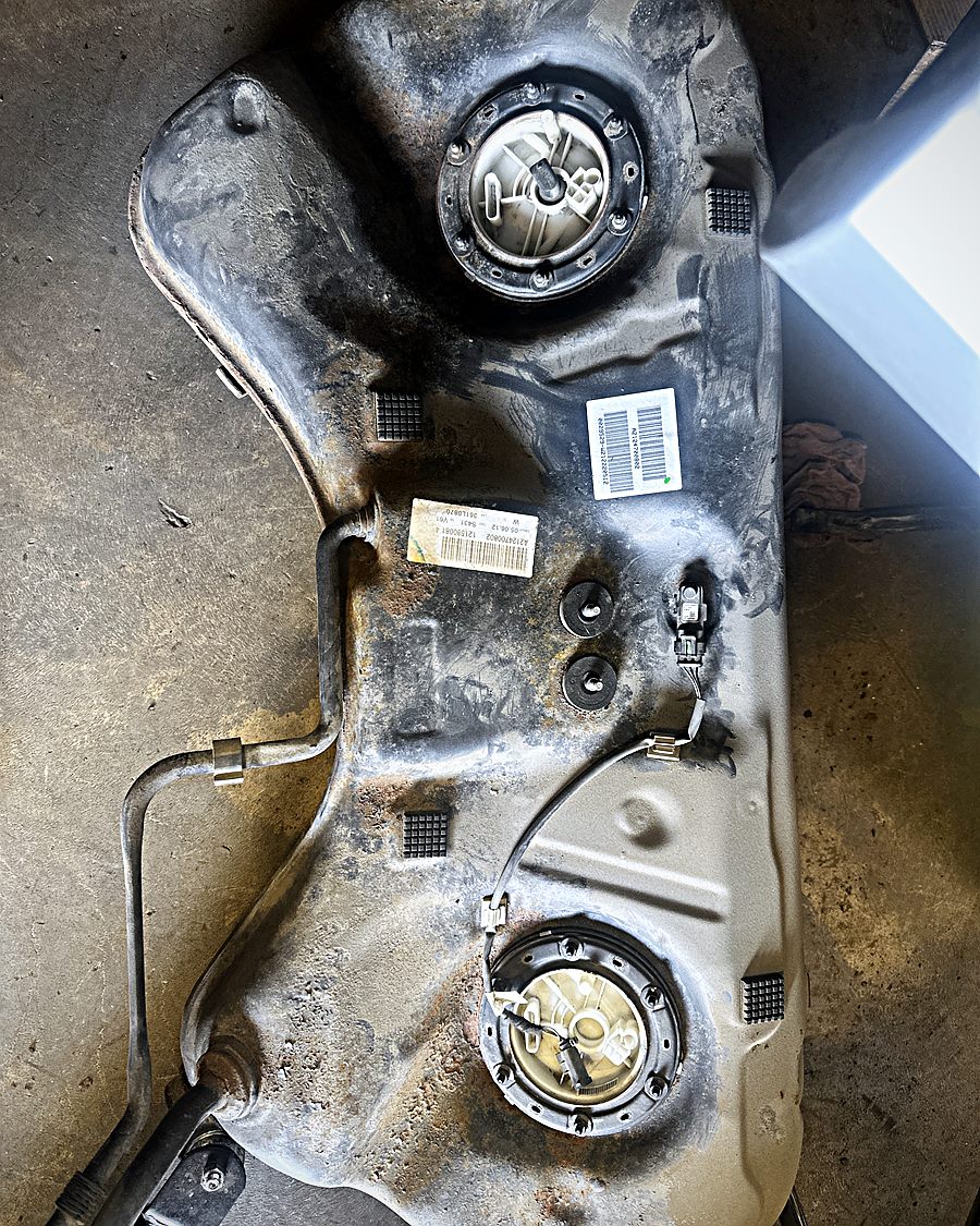 Fuel tank removed from a vehicle with both pump assemblies visible